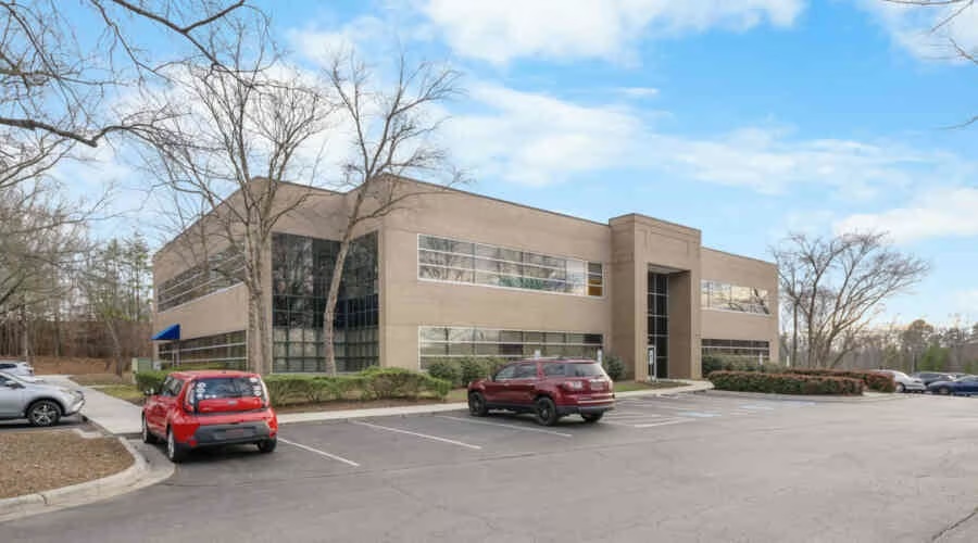 4160 Piedmont Parkway office building with its main entrance, windowed facade, and surface parking